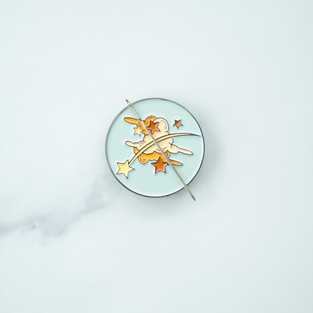 Clouds and starry sky needle minder with needle on grey marble background 